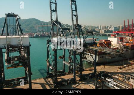 HongKong, China - November 2019: Cranes loading shipping container on freight harbor logistics centre in Hong Kong Stock Photo