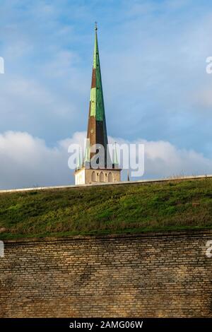 View from the east of St. Olaf's Church or St. Olav's Church, towering above the old city wall. Tallinn, Estonia, Stock Photo