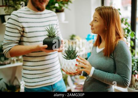 Young smiling people florists working in the home Stock Photo