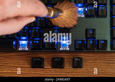 control alt and delete keys lie next to the keyboard, which is cleaned with a brush from dust Stock Photo