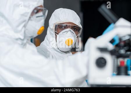 selective focus of african american scientist looking at his colleague Stock Photo