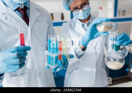 cropped view of biologists doing test in lab Stock Photo
