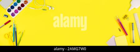 Banner made from different school supplies on bright yellow paper background. Back to school background. Flat lay, copy space. Stock Photo