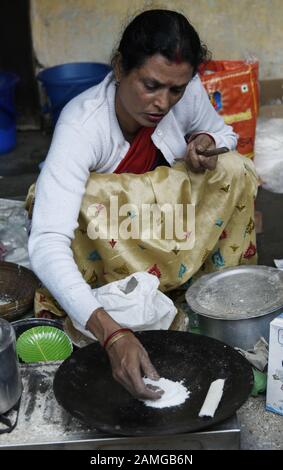 An Assamese woman prepares 'pitha', a traditional sweet, ahead of ...