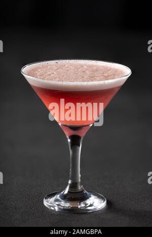 Classic Clover Club cocktail in a cocktail glass on a dark background. Stock Photo