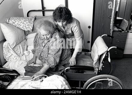 Carer & elderly disabled woman in residential care, Nottingham UK 1991 Stock Photo