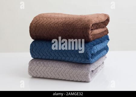 stack of folded soft blankets isolated on white background Stock Photo