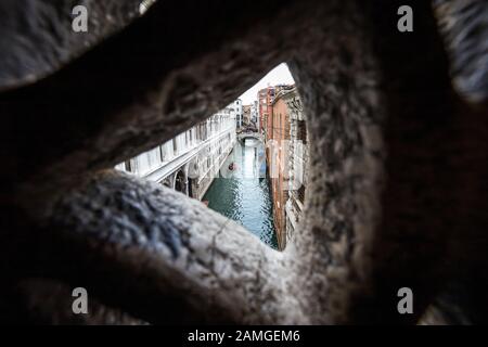 Looking out from the Bridge of Sighs showing the view of Venice the prisoners would have seen as they were lead over to the prisons within the Palace. Stock Photo