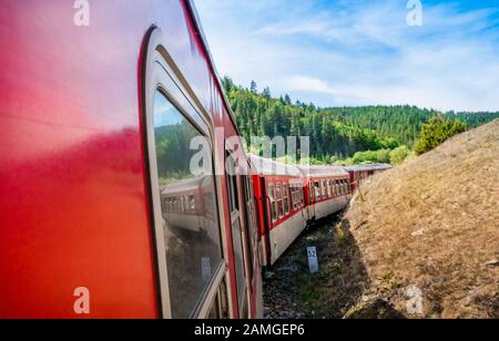 red retro train in Bulgaria mountains, Alpine railway in the Balkans Stock Photo