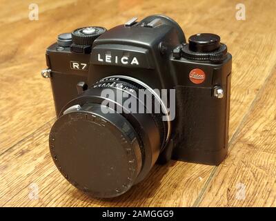 Close-up of Leica R7 film camera with 50mm prime lens on light wooden surface, November 27, 2019. () Stock Photo