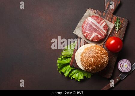 Tasty grilled home made burgers with beef, tomato, cheese, cucumber and lettuce. Stock Photo