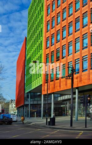 London, United Kingdom - January 19th 2016: Unidentified people in front of Central Saint Giles building with colorful facade including different shop Stock Photo