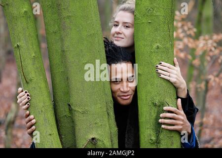 Young intercultural and happy student couple during a winter walk in Bottrop, Germany. Stock Photo