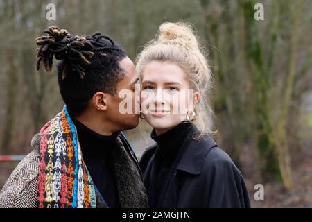 Young intercultural caucasian-hispanic student couple during a winter walk in Bottrop, Germany. Stock Photo