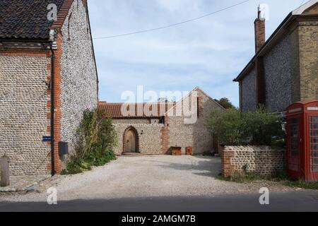 Sunbeams traditional flint house in the village of Cley Next The Sea, North Norfolk, UK Stock Photo