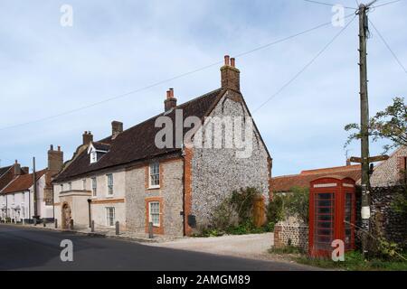 Sunbeams traditional flint house in the village of Cley Next The Sea, North Norfolk, UK Stock Photo