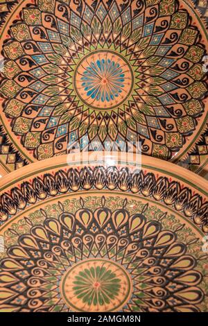 Ethnic Uzbek ceramic tableware. Decorative ceramic plates with traditional uzbekistan ornament. Stock Photo