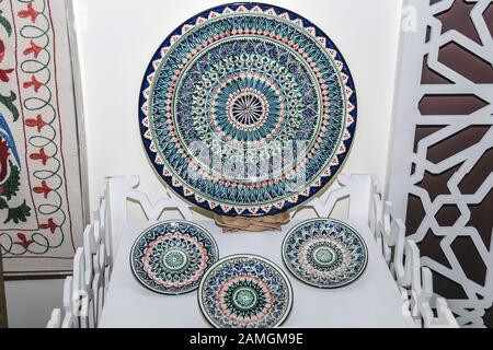 Ethnic Uzbek ceramic tableware. Decorative ceramic cups  and plates with traditional uzbekistan ornament.