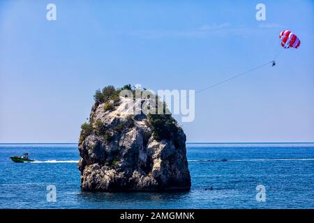 Parachute behind a boat on a summer holiday beach in Parga Epirus, Greece, Europe. Stock Photo