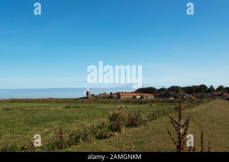 View of Cley Windmill across the reed beds and marshes that surround the village of Cley Next The Sea, North Norfolk, UK Stock Photo