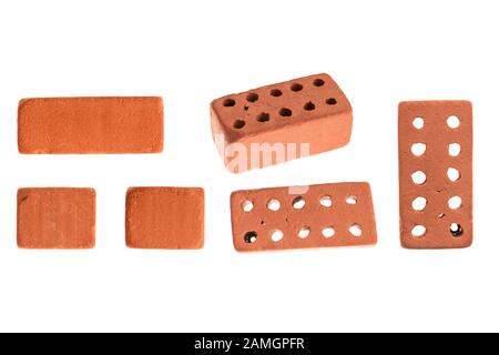 Decorative, facing, ceramic, red, used in construction brick with holes under different focus and in section. Isolated on a white background. Stock Photo