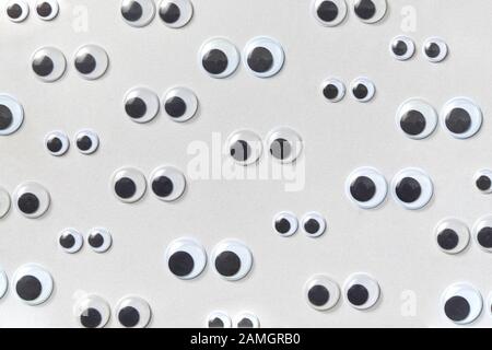 Googly eyes are small plastic craft supplies used to imitate eyeballs  isolated on white background., Stock image