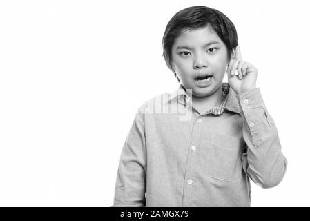 Studio shot of cute Japanese boy pointing finger up Stock Photo