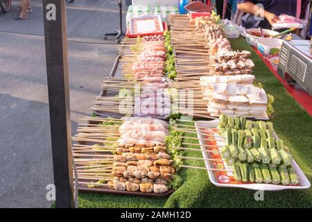 Raw material skewered on wood Waiting to be grilled and then coat with chilli mala. Stock Photo