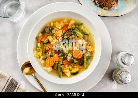 Spring vegetable soup on light background Stock Photo