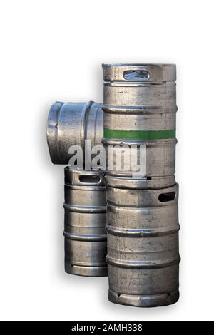 four silver-colored metal beer barrels, one with a green ring around it Stock Photo