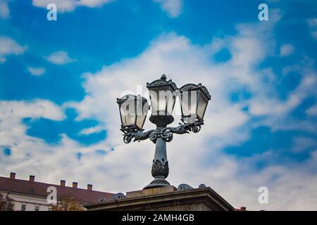 Beautiful street lamp with a cloudy Budapest day in the background. Location Liberty Bridge in Budapest over Danube Stock Photo