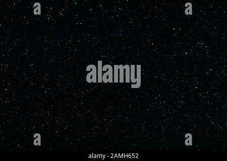 multi-colored crystalline particles, flickering magic dust on black background Stock Photo