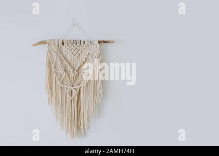 Hand woven black macrame with white beads hanging on wall Stock Photo -  Alamy