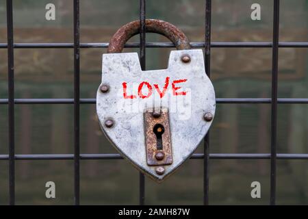 hanged love padlock on a fence of a bridge for valentines day Stock Photo