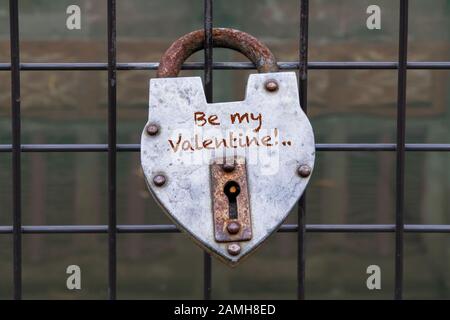 hanged love padlock on a fence of a bridge for valentines day Stock Photo