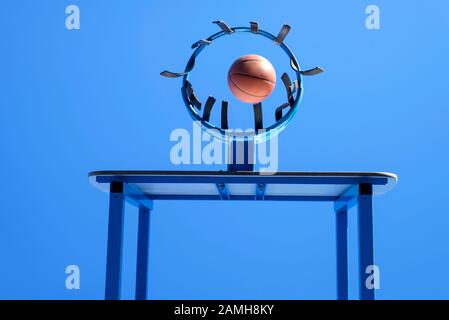 image of a ball beside a basketball hoop, basket against blue sky. Outdoor basketball court Stock Photo