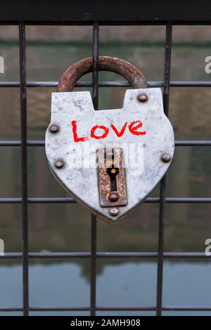 hanged love padlock on a fence of a bridge for valentines day Stock Photo