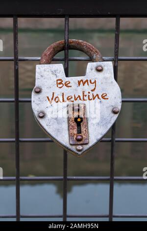hanged love padlock on a fence of a bridge for valentines day Stock Photo