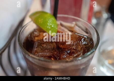 Close-up of Diet Coca Cola with lime wedge garnish, a common method for distinguishing diet sodas in a restaurant setting, Danville, California, November 28, 2019. () Stock Photo