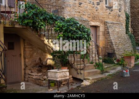 Street scene Goult ,provence , France. ivy growing up stair rail to terrace, medieval hill top village.stone buildings. Stock Photo