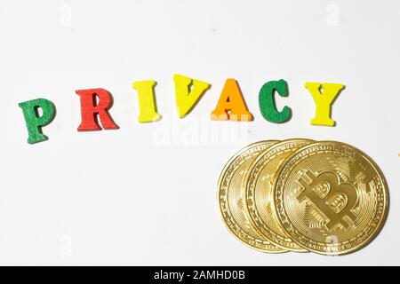 Privacy word made with letterboard and bitcoin coins on white background top view. Flat lay with copy space Stock Photo