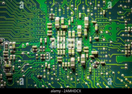 Close-up board with micro chips from an electrical appliance or computer. Concept of modern technology. Concept of electronics and microchips. SMD Stock Photo