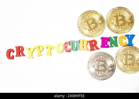 Cryptocurrency concept. Letters and bitcoin coins top view on white background Stock Photo