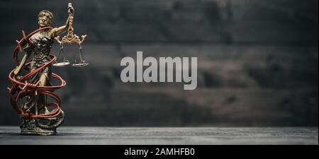 Law and Justice, Legality concept, Scales of Justice, Justitia, Lady Justice on a black wooden background. Stock Photo