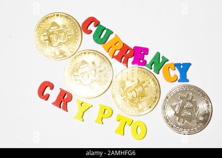 Words currency and crypto with bitcoin top view. Flat lay with white background Stock Photo