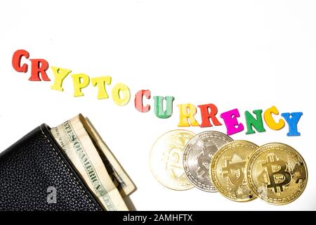 Word cryptocurrency made with letterboard on white background. Bitcoin and dollar banknote in wallet flat lay Stock Photo