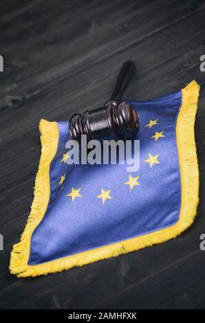 Law and Justice, Legality concept, Judge Gavel and European Union flag on a black wooden background.