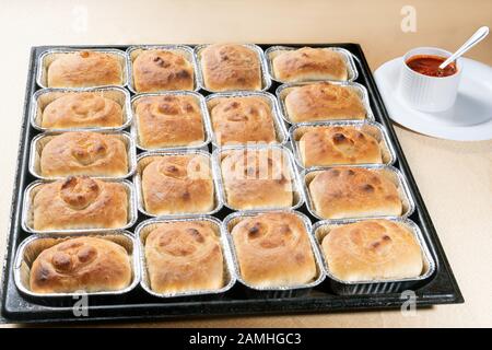 freshly baked soft hot buns with tomato sauce Stock Photo