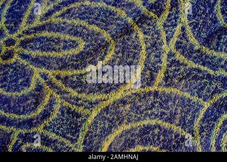 Blue woven texture with yellow patterns. Background with copy space Stock Photo