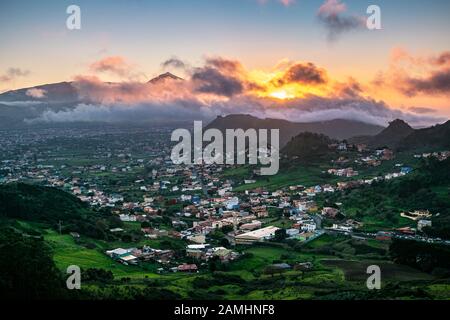 Beautiful sunset over San Cristóbal de La Laguna with iconic Teide in the background, seen from Mirador de Jardina, Northern Tenerife, Canary Islands, Stock Photo